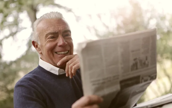 older gentleman reading newspaper