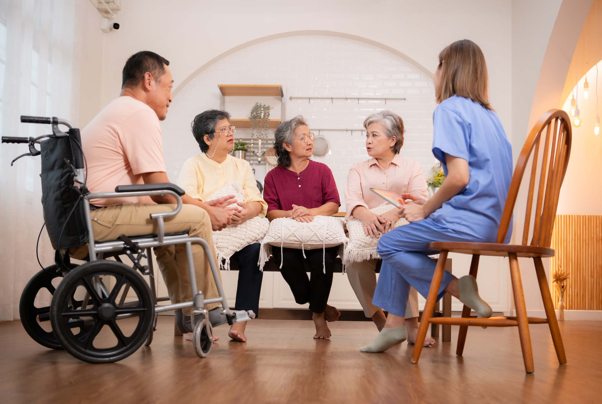 Elderly people talking with nurse in nursing home